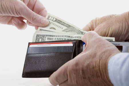 Image of a hand taking money from a working man's wallet over a white background,