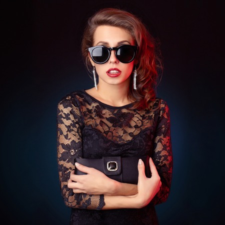 Fashion studio photo of beautiful stylish lady in sunglassesの写真素材