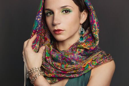 beautyful young brunette woman in scarf.fashionable girl with accesories. arabian slyleの写真素材