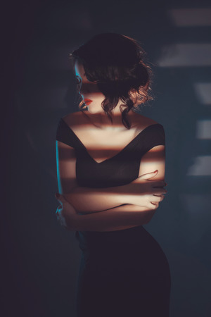 fashion portrait of Beautiful young woman in shadow. sensual Model girl in dressの写真素材