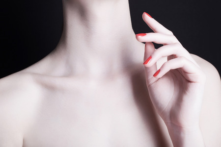 female neck. hand of young woman with red manicureの写真素材
