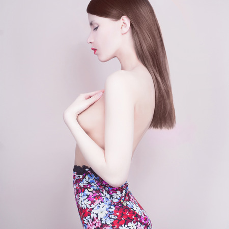 beautiful young woman. flower dress.closes the chestの写真素材