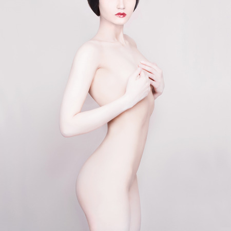  beautiful young woman. white skin.closes the chestの写真素材