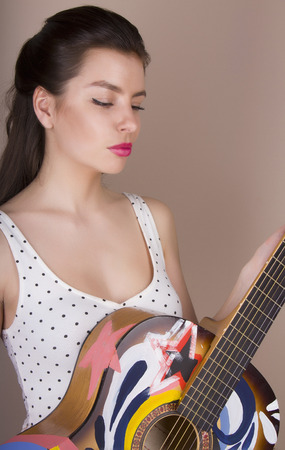 beautiful young woman with acoustic guitarの写真素材