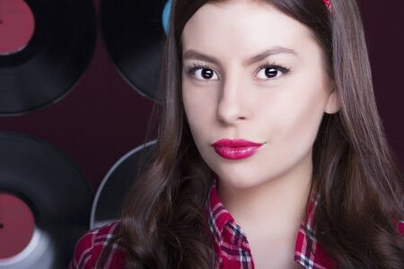 Close-up portrait of beautiful Young woman.simple girl in shirt.vinyl backgroundの写真素材