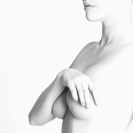 nude beautiful young woman. sexy body girl closes the chestの写真素材