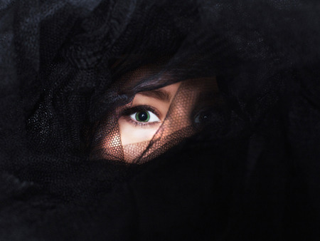 beautiful woman eye under the black veil.fashion beauty unusual portraitの写真素材