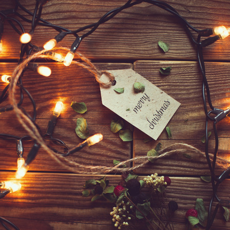 wooden background with festive garland lamps.new year ready still life.mery christmasの写真素材