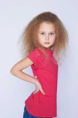 beautiful little girl with healthy curly hair.funny childの写真素材