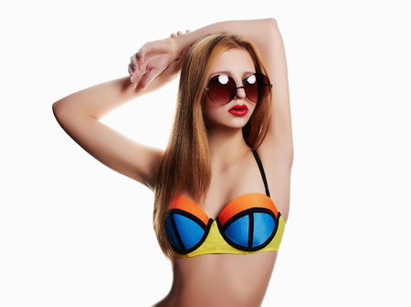 sexy beautiful girl with in bikini and sunglasses. isolated young summer womanの写真素材