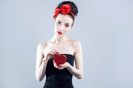 beautiful girl with red heart gift box. beauty young woman.Valentine's Dayの写真素材