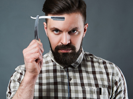 fashion Portrait of bearded man with vintage straight razor.stylish handsome boyの写真素材