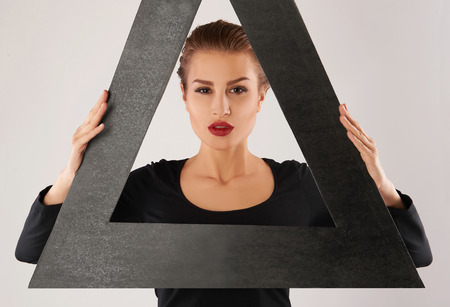 unusual portrait of beautiful young woman.fashion portrait of sexy girl in a triangleの写真素材