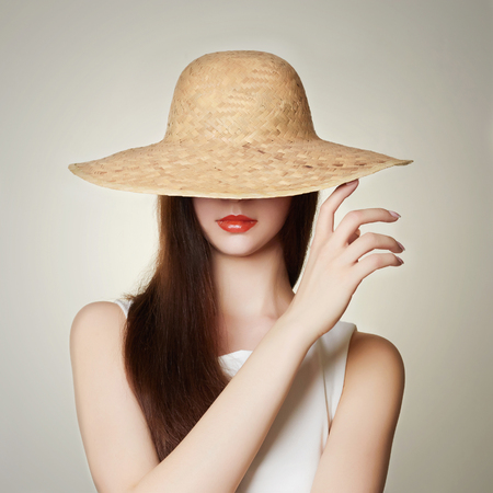 fashion portrait of beautiful woman in hat.beauty girl with red lipsの写真素材