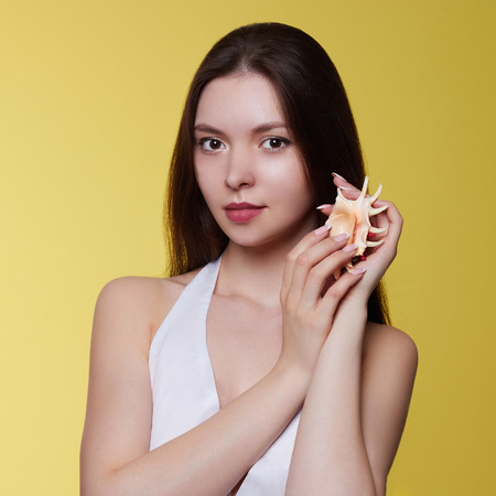 portrait of beautiful young woman with sea shell.beauty summer girl