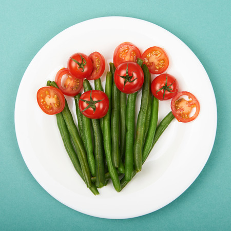 healthy food still life. vegetarian plate.siliculose haricot and tomatosの写真素材