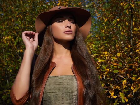 sunny autumn fashionable Beautiful Woman in hat.Beauty Girl walking in forestの写真素材