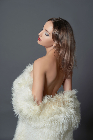 Beautiful woman in fur.winter fashion.Beauty sexy Model Girl with healthy hair. Woman in Luxury Fur coatの写真素材