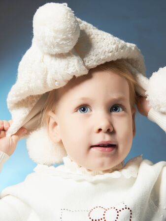 happy smiling little girl in hat.winter style child.knitted woolen capの写真素材