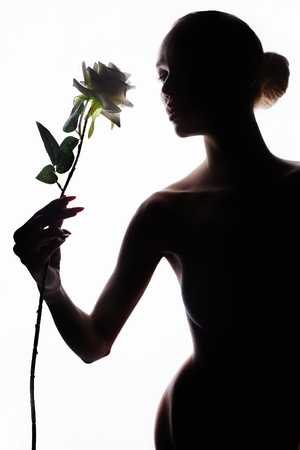 nude beautiful woman with flower.fashion art photo of perfect body model girl silhouetteの写真素材
