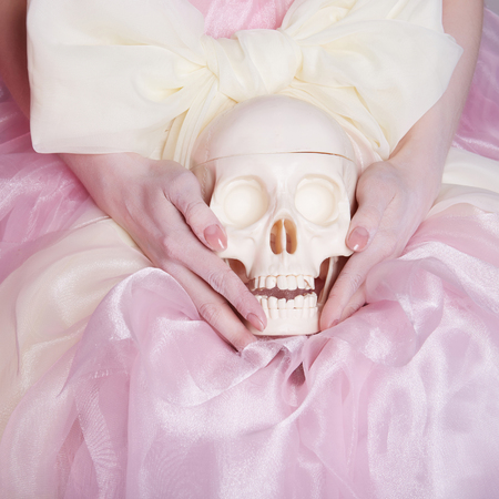 woman in a silk dress holds a skull.unusual photoの写真素材
