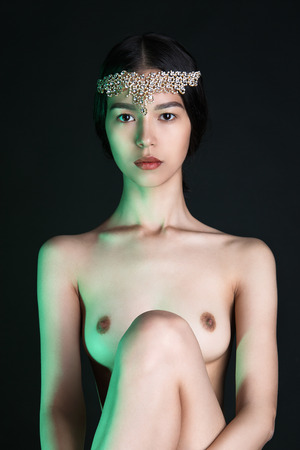 beautiful nude asian woman princess.naked sexy girl with perfect body and jewelry on her headの写真素材