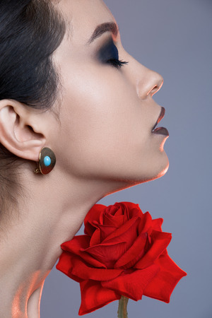 pure make-up woman with red rose flower.female face and flowerの写真素材