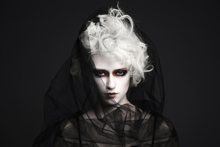 fashion halloween make-up girl with white skin and hair.young woman in veil.black widow style