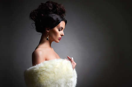 fashion portrait of beautiful girl in fur. beauty young woman with hairstyleの写真素材