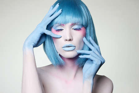 Beautiful girl with Blue Hair and Paint. Fairy beauty young womanの写真素材