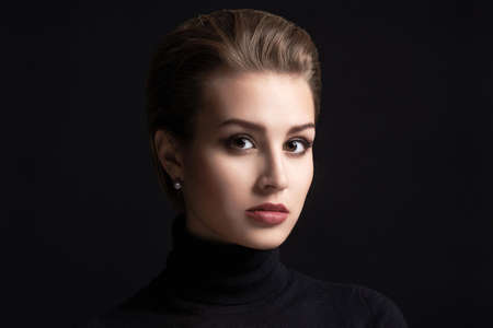 beautiful woman.Closeup beauty portrait of a young brunette model in a black roll neck jumper.sensual girl with short hairの写真素材