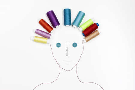 human face made of different sewing items. balls of thread like curlers. Funny still lifeの写真素材