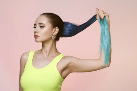 Beautiful girl with blue hair. beauty young woman with jewelry and color Hairの写真素材