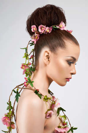 beautiful naked woman like a flower. nude girl with flowers and makeupの写真素材
