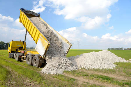 Normandy, France, October 2014.
Dump truck dumping marly limestones in a field in order to reduce acidity of the soilのeditorial素材