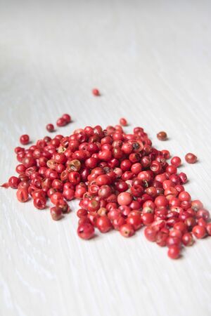 Dried rose pepper on a wooden tableの写真素材