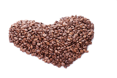 Heart of coffee beans on white