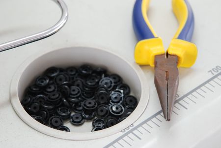 pliers and buttons on the worktableの写真素材