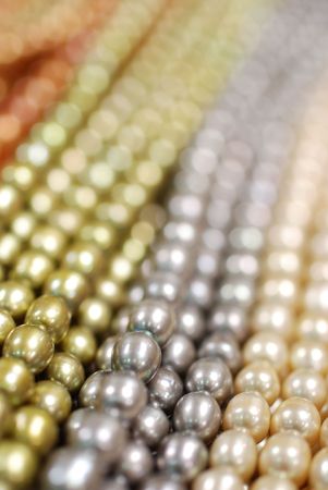closeup of various colorful pearl strandsの写真素材