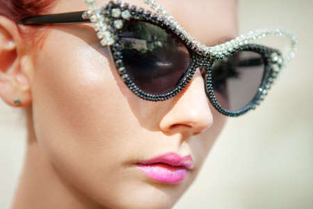 woman with pink lipstick wears luxury sunglassesの写真素材