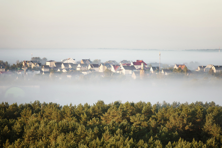 Buildings sticking out of the fog. Wide panorama. soft focusの写真素材