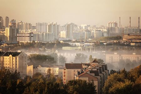 Buildings sticking out of the fog. Wide panorama. soft focusの写真素材