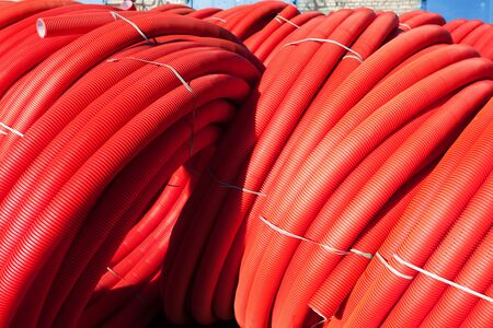 Tubing. Red plumbing pipe plastic pvc close-up.の写真素材
