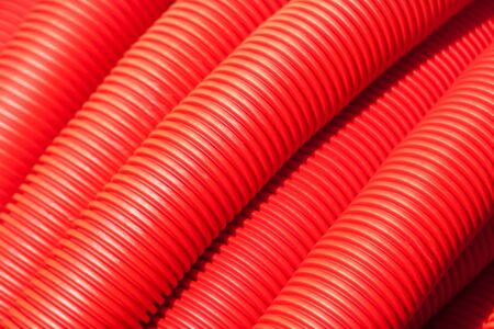 Tubing. Red plumbing pipe plastic pvc close-up.の写真素材