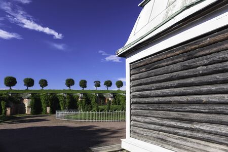 Ancient wall and three trees on the background of blue sky in Peterhofの写真素材
