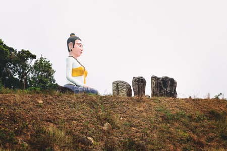 Statue of sitting Buddha in the clouds fog, Cambodia, Bokor Mountains, Kampot provinceの写真素材