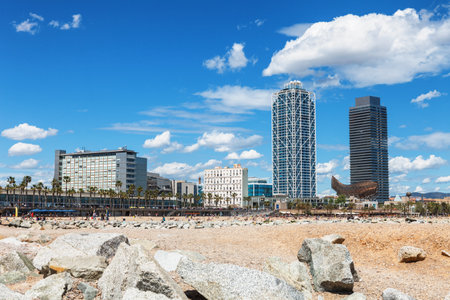 Barcelona, Spain - April 17, 2016: panoramic view on Barceloneta with modern architecture buildings sand beach on sunny day.のeditorial素材
