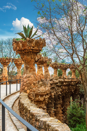 columns among the trees made of stone in Park Guell designed by Antoni Gaudi in Barcelona, Spain, modernism styleのeditorial素材