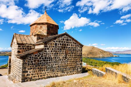 Scenic view of an old Sevanavank church in Sevan, Armenia on sunny day blue sky and fluffy cloudsの写真素材