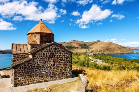 Scenic view of an old Sevanavank church in Sevan, Armenia on sunny day blue sky and fluffy cloudsの写真素材